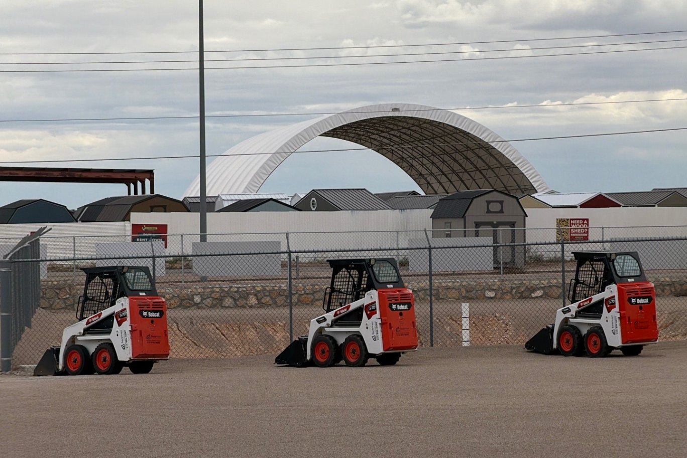 Bobcat skid steer moving fill dirt on a residential landscape job in El Paso